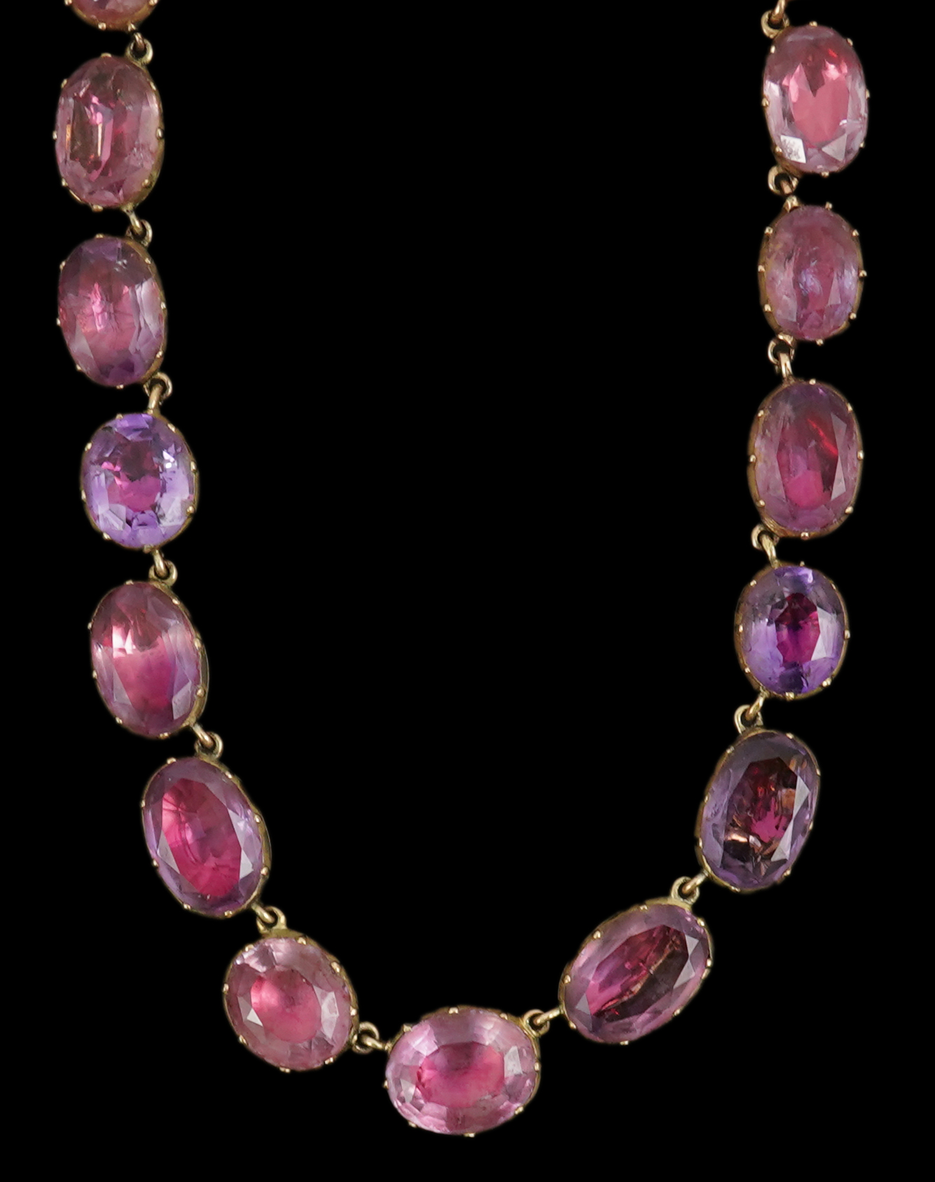 A 19th century gold and graduated oval cut foil backed amethyst or rock crystal set riviere necklace